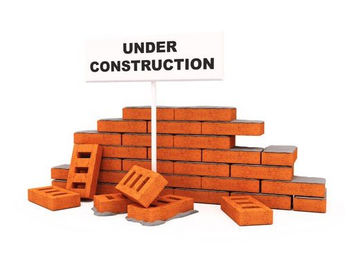 Image of commercial foundation repair on bricks with "under construction" sign 