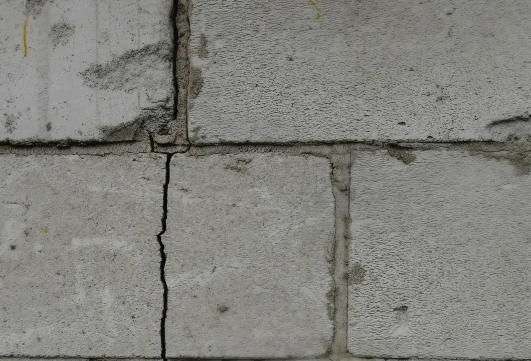 a cracked brick wall due to foundation damage a cracked brick wall due to foundation damage