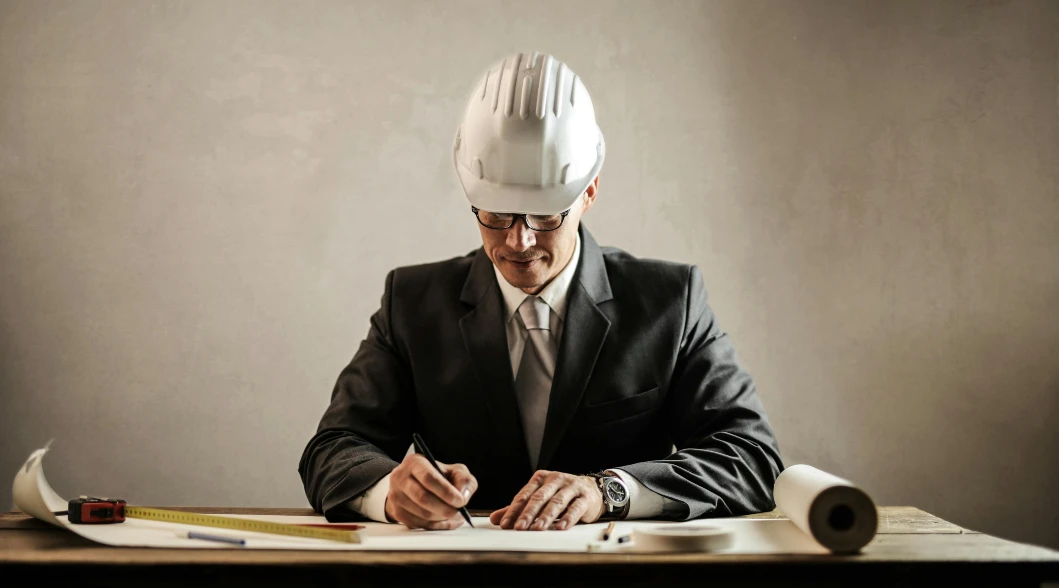 structural engineer wearing hard hat while writing structural engineer wearing hard hat while writing