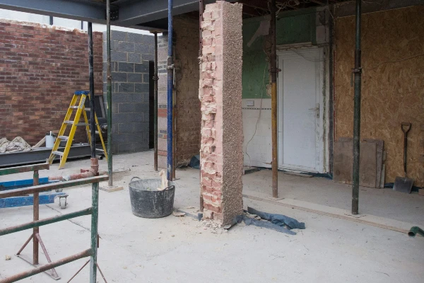 blue and yellow step ladder beside brown brick wall blue and yellow step ladder beside brown brick wall