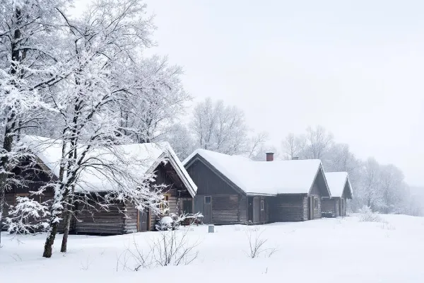A winter scene shows a pile of houses blanketed in snow A winter scene shows a pile of houses blanketed in snow