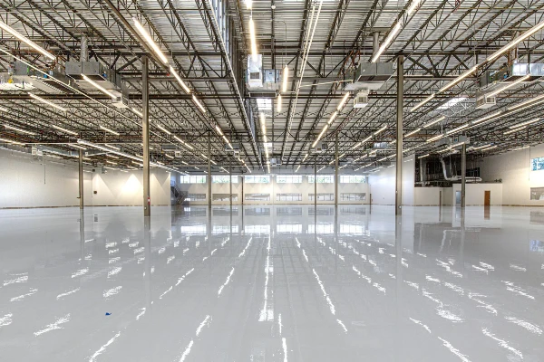 Shiny warehouse floor with overhead lights and ceiling Shiny warehouse floor with overhead lights and ceiling